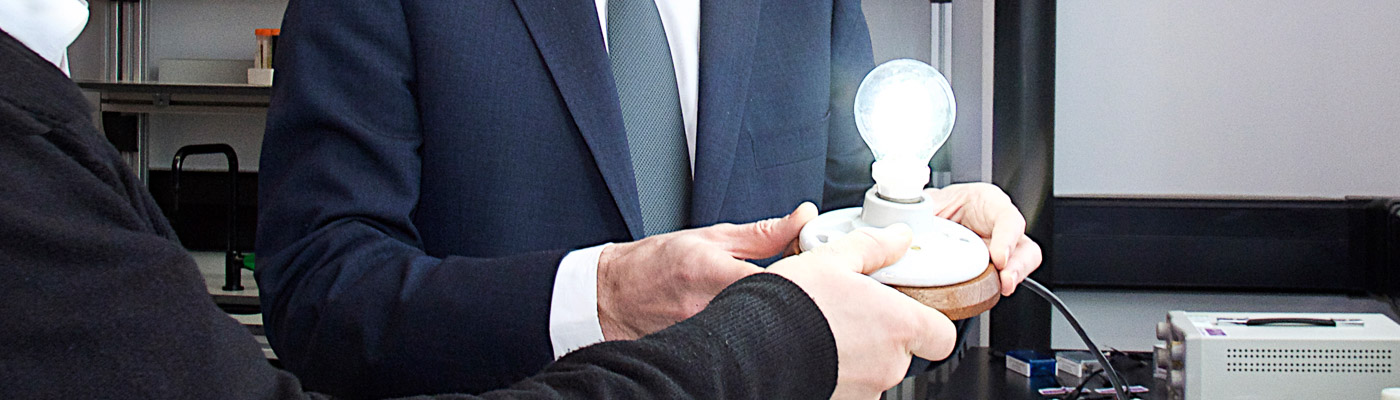 two people holding a graphene lightbulb