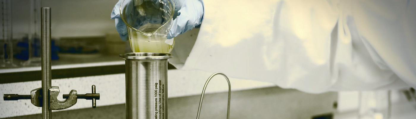 A person pouring a liquid into a test tube