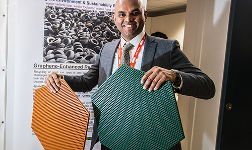 Vivek Koncherry, founder of SpaceMat, holding two graphene-enhanced rubber mats