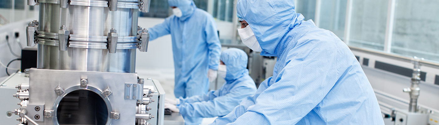 Researchers preparing a CVD graphene sample in a clean room